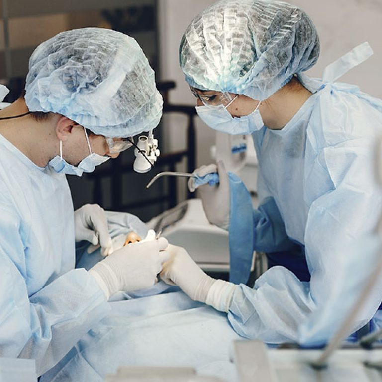 uniquedent_web_services_0004_surgeons-performing-operation-in-a-sterile-environ-2026-03-16-00-41-24-utc