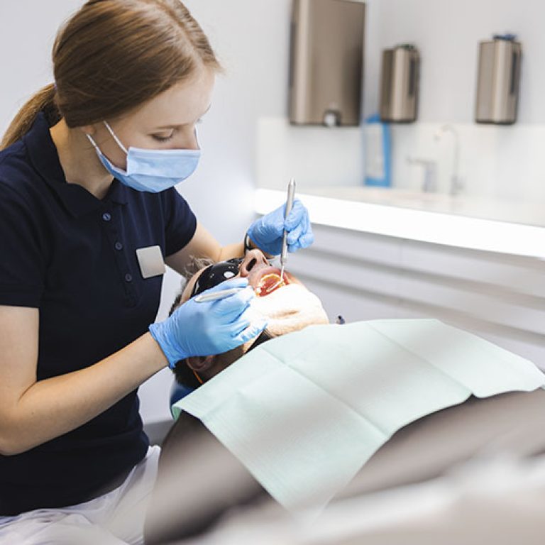 uniquedent_web_services_0010_dentist-performs-dental-check-up-on-patient-2026-03-10-03-07-46-utc